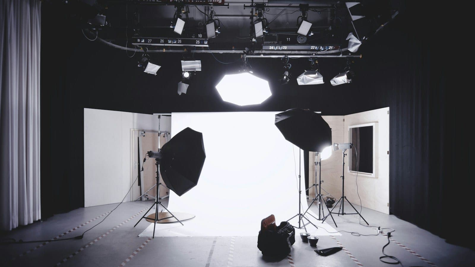 Photographer working in a studio with softboxes