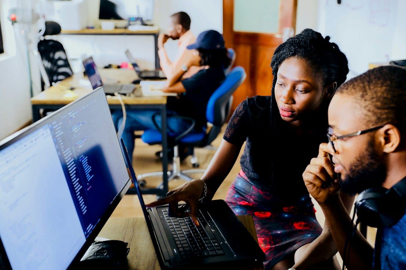 Two developers looking at a laptop screen together