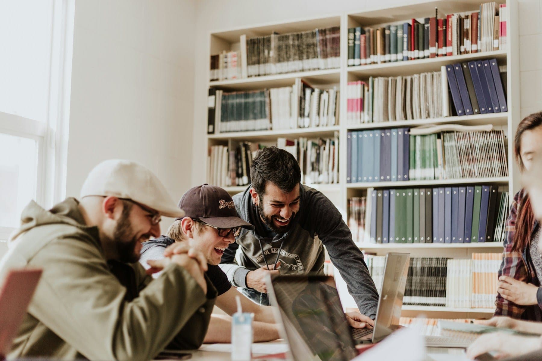 Students working together at a long table in a library